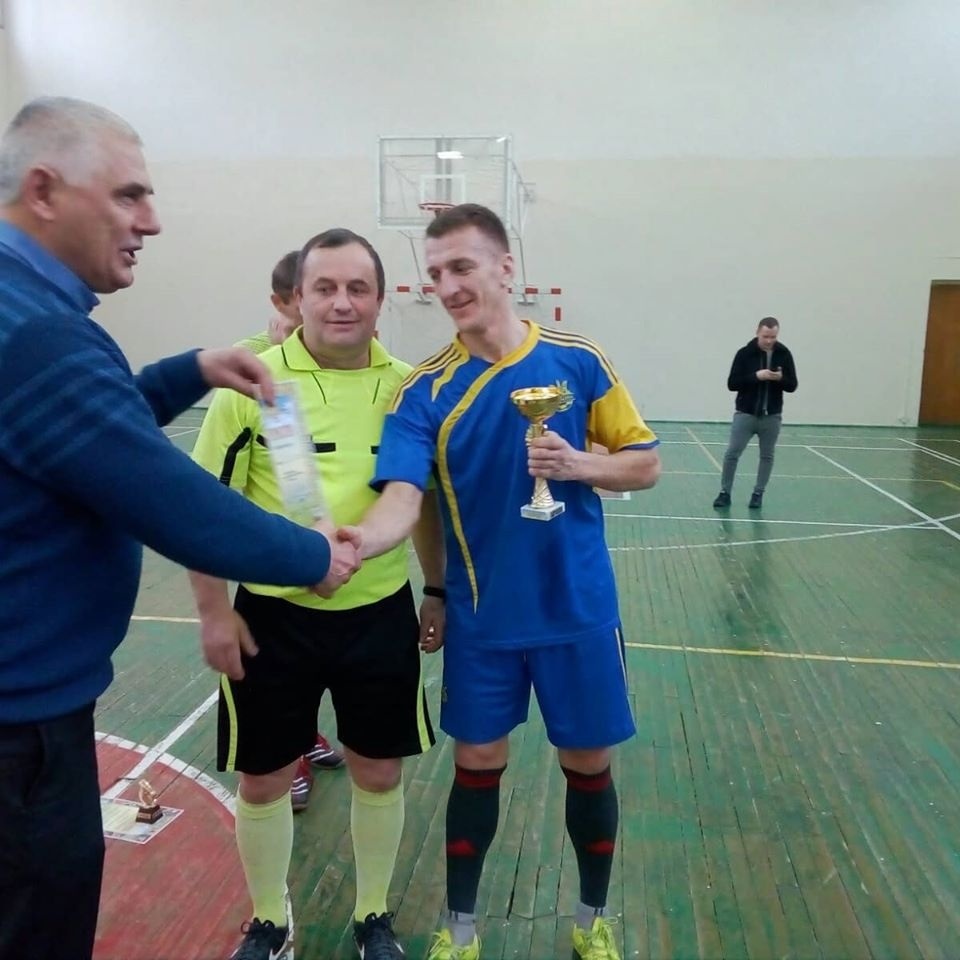 Нагороди за перше місце у футзальному чемпіонаті району отримує капітан переможців Юрій Ткачук (крайній справа)